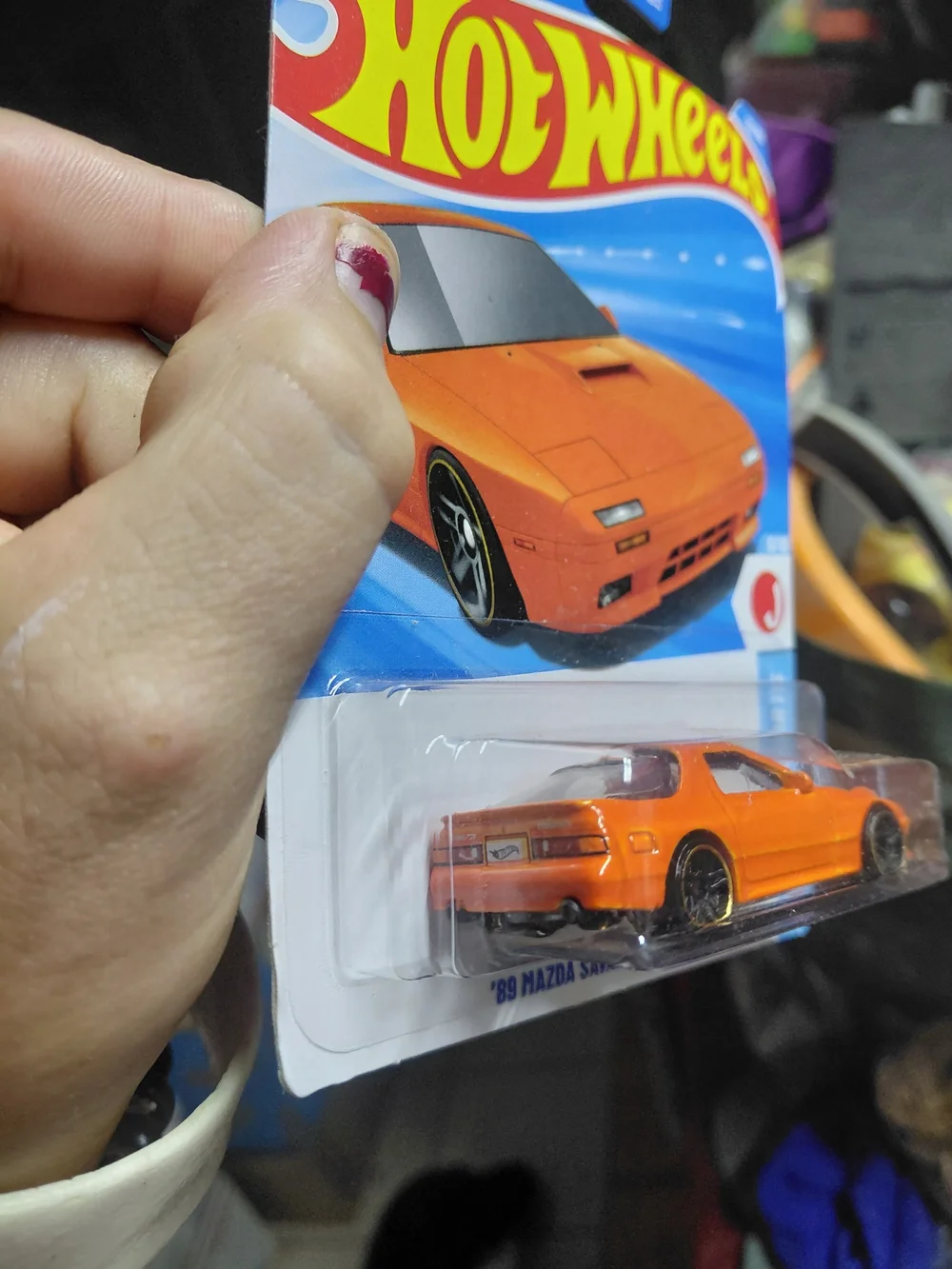 the Hot Wheels '89 Mazda Savanna RX-7 FC3S in orange, part of the 2026 HW J-Impo
